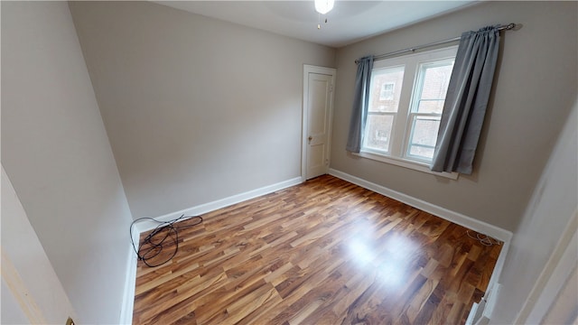 empty room with wood-type flooring and ceiling fan