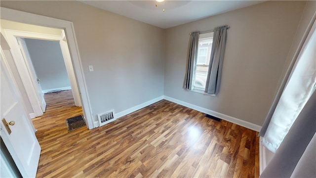 empty room featuring hardwood / wood-style flooring and ceiling fan