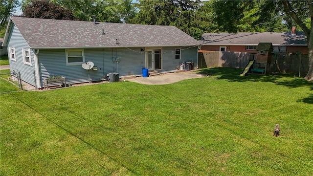 202 Lakeview Dr, Catlin, IL 61817 - back of house featuring a playground, roof with shingles, and a patio area
