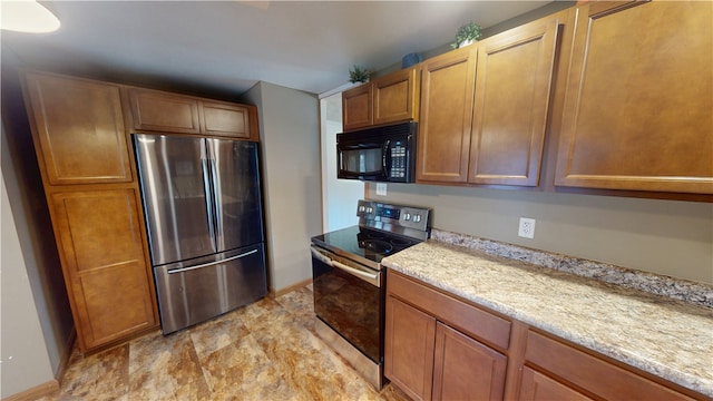 202 Lakeview Dr, Catlin, IL 61817 - kitchen with appliances with stainless steel finishes, brown cabinets, and light stone counters