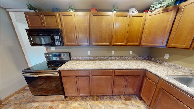 202 Lakeview Dr, Catlin, IL 61817 - kitchen with black microwave, electric range, and brown cabinetry