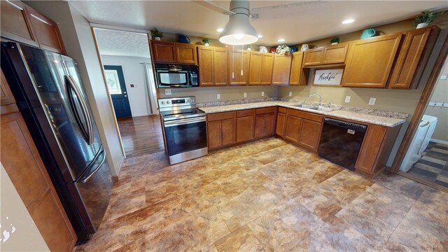 202 Lakeview Dr, Catlin, IL 61817 - kitchen featuring black appliances, recessed lighting, light stone counters, pendant lighting, and brown cabinets