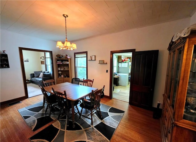 310 N Ellen St, Homer, IL 61849 - dining space with hardwood / wood-style floors, a chandelier, and baseboards