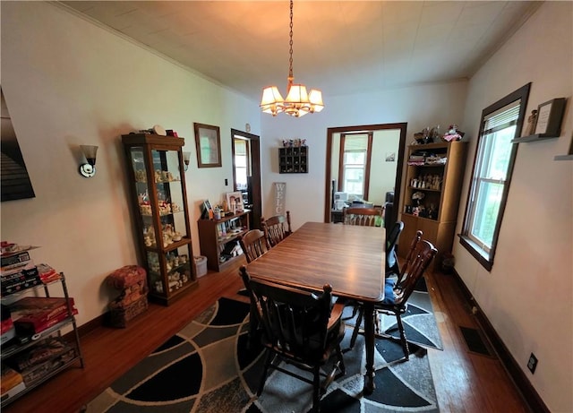 310 N Ellen St, Homer, IL 61849 - dining room with wood finished floors, healthy amount of natural light, a chandelier, and baseboards