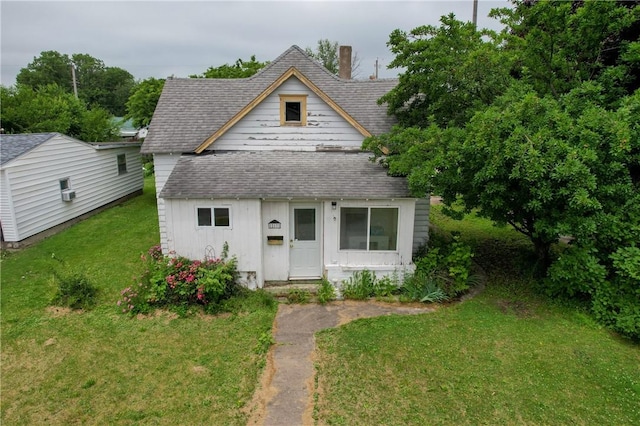 217 E Oak St, Georgetown, IL 61846 - view of front of property featuring a shingled roof, a front lawn, and an outbuilding