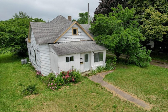 217 E Oak St, Georgetown, IL 61846 - bungalow-style house featuring roof with shingles, a front lawn, and a chimney