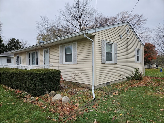 view of side of home featuring a yard