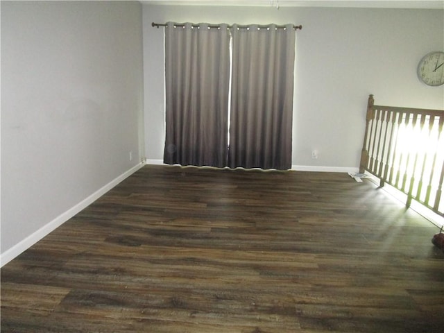 205 Franklin St, Pana, IL 62557 - spare room with baseboards and dark wood-style floors