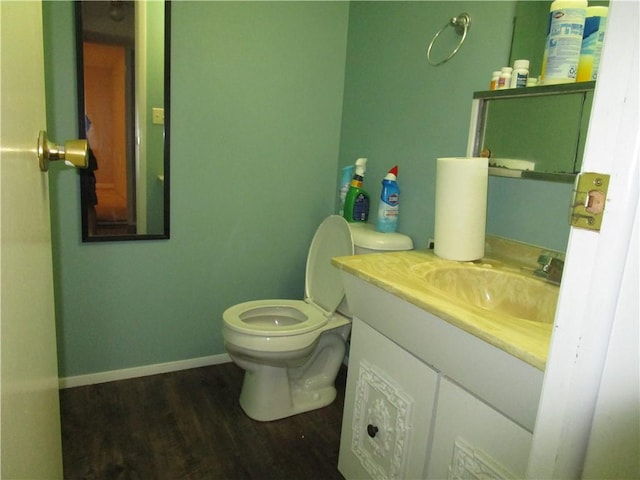 205 Franklin St, Pana, IL 62557 - bathroom featuring wood finished floors, vanity, toilet, and baseboards