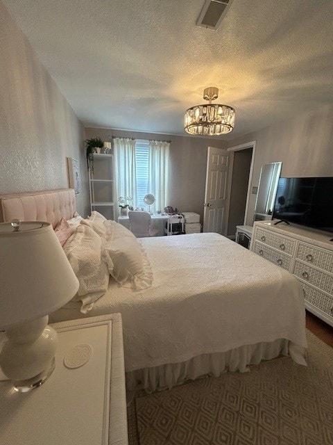 3221 E Lake Paradise Rd, Mattoon, IL 61938 - bedroom with a chandelier and a textured ceiling
