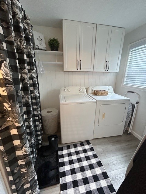 3221 E Lake Paradise Rd, Mattoon, IL 61938 - laundry room featuring washing machine and clothes dryer, cabinet space, and light wood finished floors