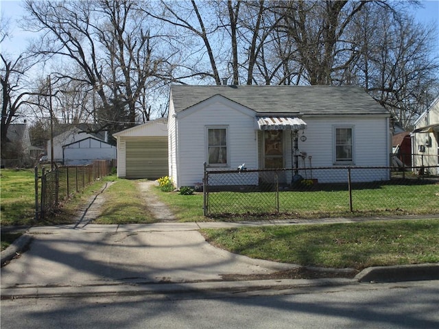 view of front of home featuring a front yard, a fenced front yard, and driveway