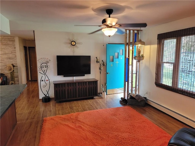 517 W Union St, Nokomis, IL 62075 - living room featuring ceiling fan, a baseboard radiator, and wood finished floors