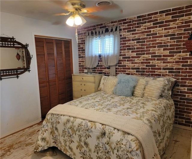517 W Union St, Nokomis, IL 62075 - bedroom with a closet, a ceiling fan, light wood-style floors, and brick wall