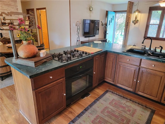 517 W Union St, Nokomis, IL 62075 - kitchen with black appliances, plenty of natural light, dark countertops, and light wood-style flooring