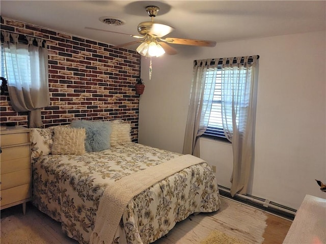 517 W Union St, Nokomis, IL 62075 - bedroom with wood finished floors, a ceiling fan, and brick wall
