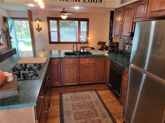 517 W Union St, Nokomis, IL 62075 - kitchen with black appliances, a ceiling fan, light wood-style flooring, and dark countertops