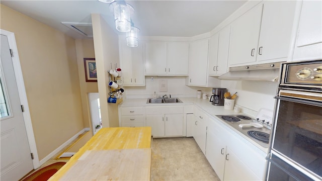 602 Maple Dr, Catlin, IL 61817 - kitchen featuring oven, electric cooktop, under cabinet range hood, and white cabinetry