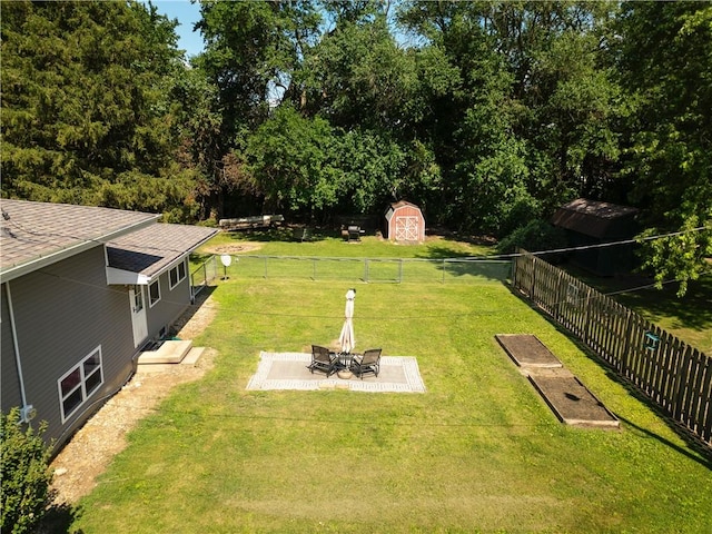 602 Maple Dr, Catlin, IL 61817 - fenced backyard with a patio area and a storage shed