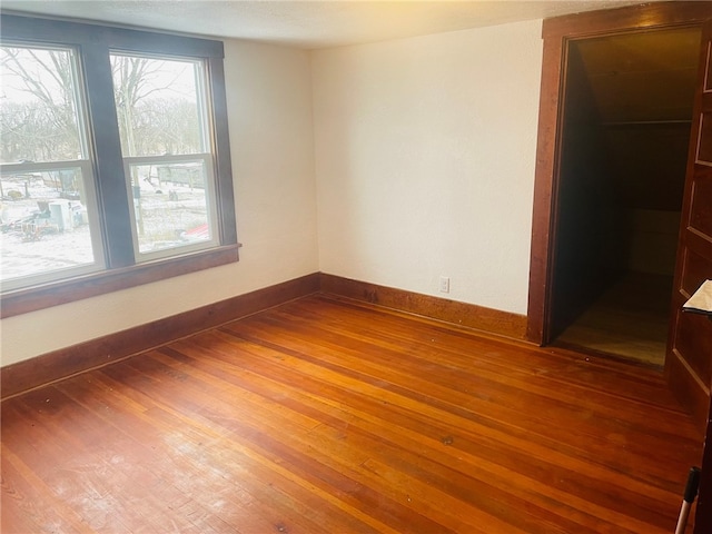 spare room with hardwood / wood-style floors