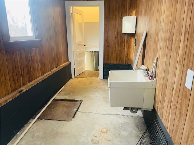 bathroom with wooden walls and sink