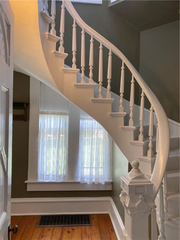 902 1st St, Charleston, IL 61920 - staircase with wood finished floors, baseboards, and a towering ceiling