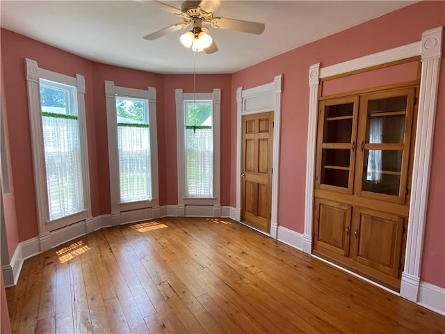 902 1st St, Charleston, IL 61920 - spare room with light wood-style floors, plenty of natural light, a ceiling fan, and baseboards