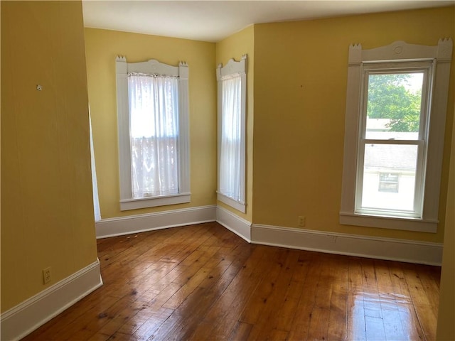 902 1st St, Charleston, IL 61920 - spare room featuring baseboards and hardwood / wood-style floors