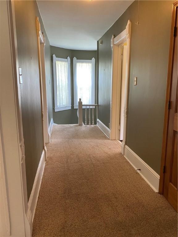 902 1st St, Charleston, IL 61920 - hallway with carpet, an upstairs landing, and baseboards