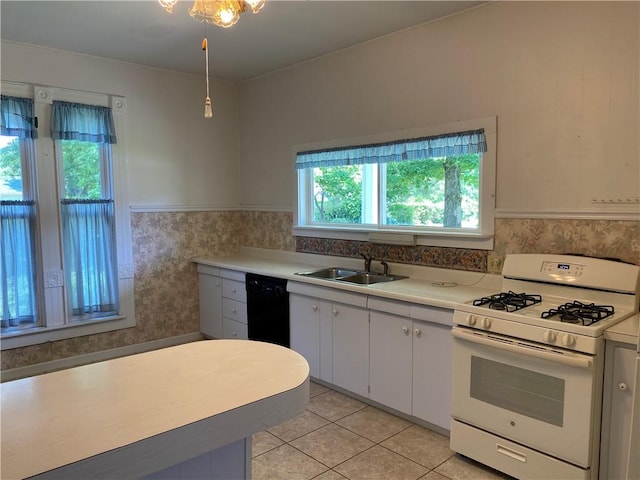 902 1st St, Charleston, IL 61920 - kitchen featuring white gas range, a sink, dishwasher, light countertops, and a wainscoted wall
