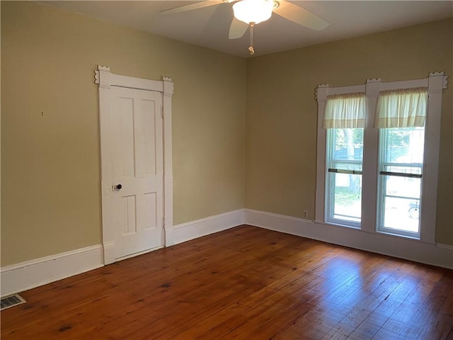 902 1st St, Charleston, IL 61920 - spare room featuring hardwood / wood-style flooring, a ceiling fan, and baseboards