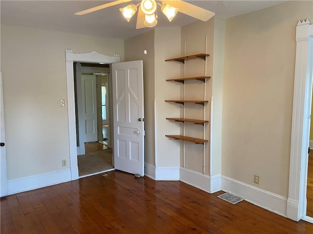 902 1st St, Charleston, IL 61920 - unfurnished bedroom with wood-type flooring and baseboards