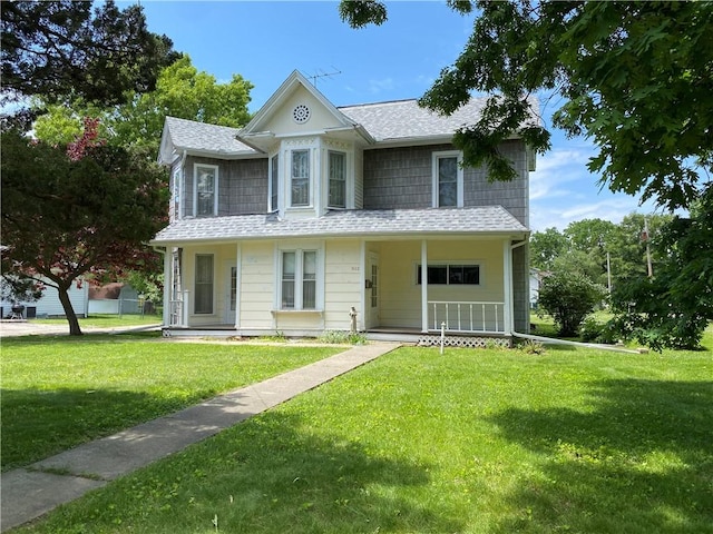 902 1st St, Charleston, IL 61920 - victorian house with a porch, a front lawn, and roof with shingles