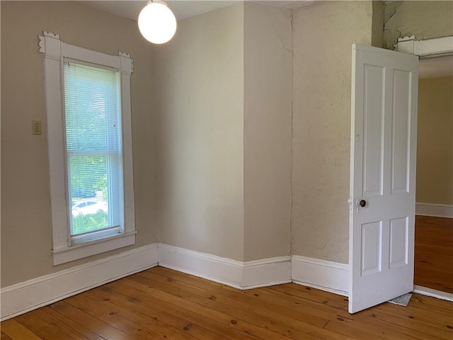 902 1st St, Charleston, IL 61920 - spare room with wood-type flooring and baseboards
