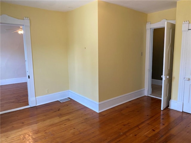 902 1st St, Charleston, IL 61920 - unfurnished room with wood-type flooring, baseboards, and a ceiling fan