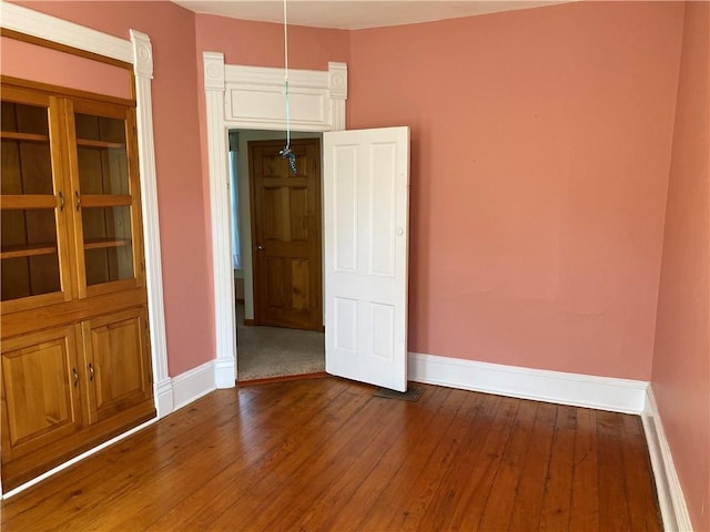 902 1st St, Charleston, IL 61920 - empty room with baseboards and dark wood-style floors