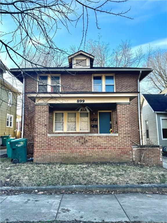 view of side of property with a porch