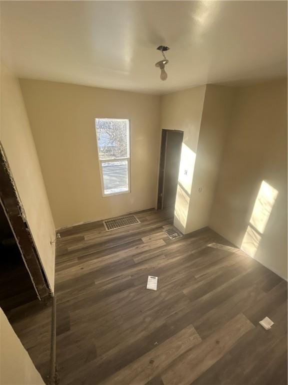 unfurnished bedroom featuring dark wood-style flooring