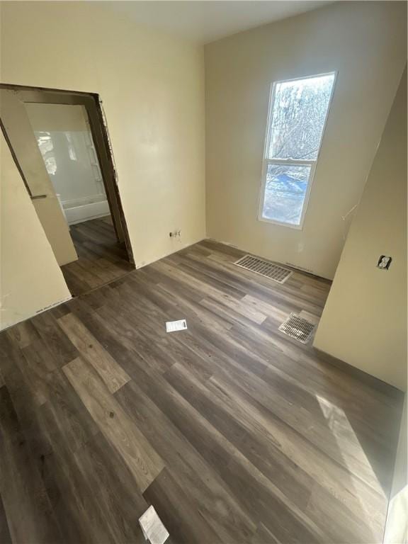 unfurnished bedroom featuring dark wood-style floors and visible vents