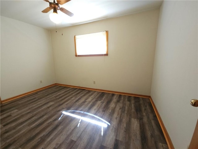 unfurnished room with a ceiling fan, baseboards, and wood finished floors