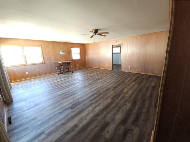 unfurnished room with dark wood-style floors, baseboards, and a ceiling fan