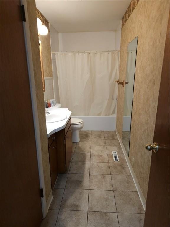 full bath with toilet, tile patterned floors, visible vents, vanity, and shower / tub combo with curtain