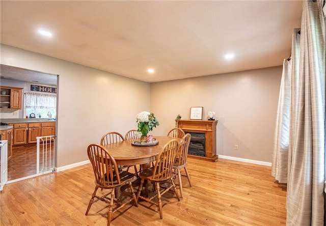 685 E Main St, Warrensburg, IL 62573 - dining space with light wood-type flooring, recessed lighting, and a fireplace