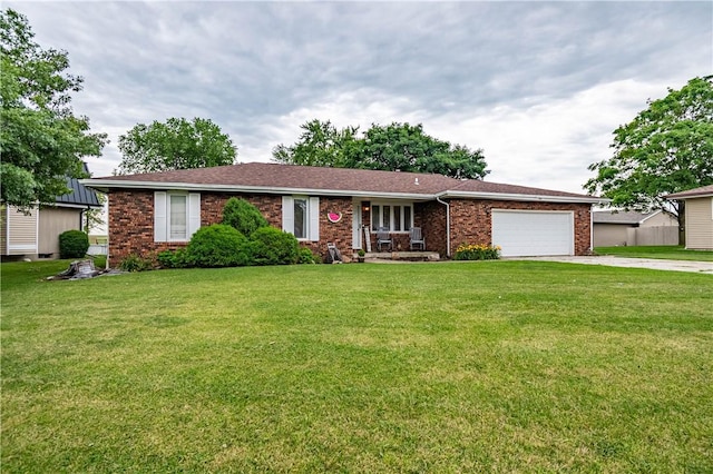 685 E Main St, Warrensburg, IL 62573 - ranch-style home featuring an attached garage, concrete driveway, brick siding, and a front lawn