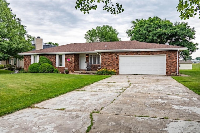 685 E Main St, Warrensburg, IL 62573 - ranch-style home with a chimney, a front yard, a garage, and concrete driveway