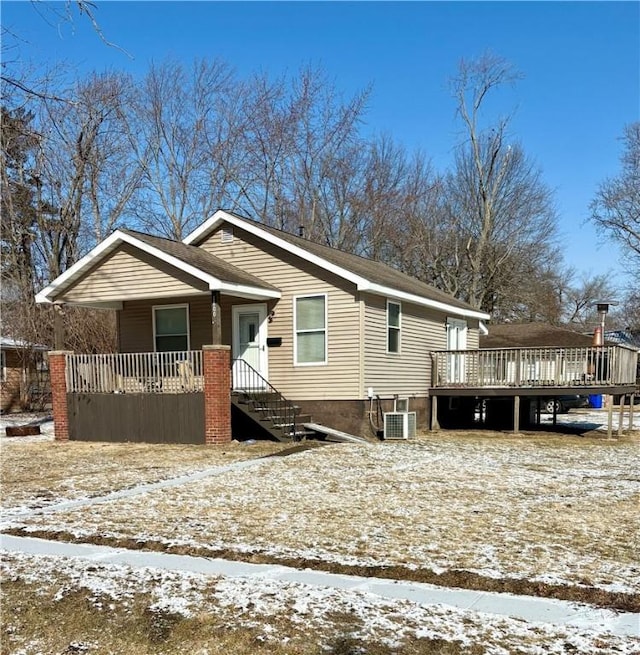 view of front of home with central AC unit and a wooden deck