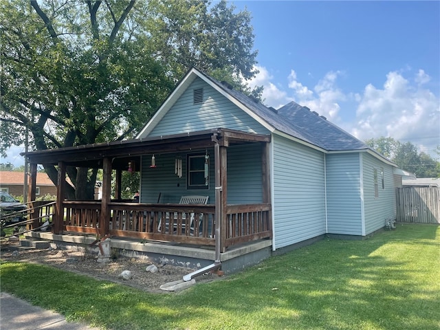 exterior space with covered porch and a yard