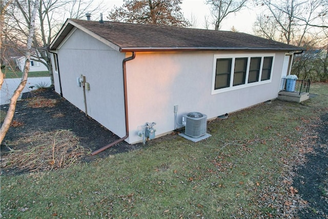 view of property exterior featuring a yard and central AC unit