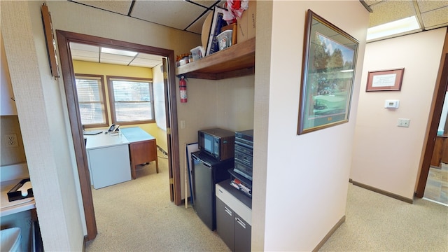 kitchen featuring a paneled ceiling, light carpet, and white fridge