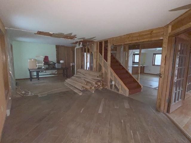 unfurnished living room with stairway and wood finished floors
